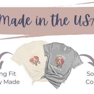 May include: Two t-shirts with different designs. The beige t-shirt has a floral design with the text "Slow Down & Soak It Up". The grey t-shirt has the same design but with the text "Slow Down & Soak It Up". Both t-shirts are made in the USA and have an amazing fit. They are ethically made and soft and comfy.