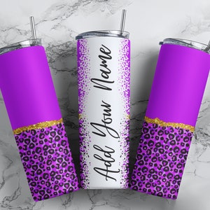May include: Three purple and gold stainless steel tumblers with a leopard print design. The middle tumbler has the text "Hold You Name" written on it.
