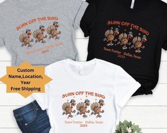 May include: Three t-shirts in athletic heather, black, and white. Each shirt features the text "BURN OFF THE BIRD" above a graphic of running turkeys. Below the graphic is "Team Trotter Dallas, Texas 2024".