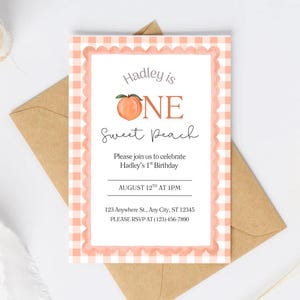 May include: A rectangular birthday invitation card featuring a peach-colored gingham border with a scalloped edge. The text reads: Hadley is ONE Sweet Peach, Please join us to celebrate Hadley's 1st Birthday, AUGUST 12TH AT 1PM, 123 Anywhere St., Any City, ST 12345, PLEASE RSVP AT (123) 456-7890.