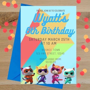 May include: A birthday invitation card featuring a large yellow star on a light blue background with four cartoon cats in superhero costumes. The text reads: PLEASE JOIN US TO CELEBRATE Wyatt's 6th Birthday SATURDAY MARCH 25TH AT 10 AM BOUNCE TOWN 123 ANY STREET, 12345 RSVP TO JESSEE (MOM) 123-123-123.