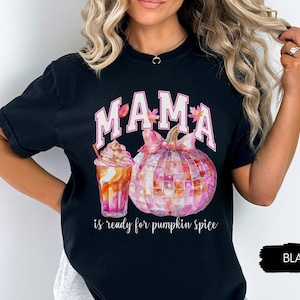 May include: Black t-shirt with a pink and white graphic of a pumpkin, a fall-themed drink, and the text "MAMA is ready for pumpkin spice".