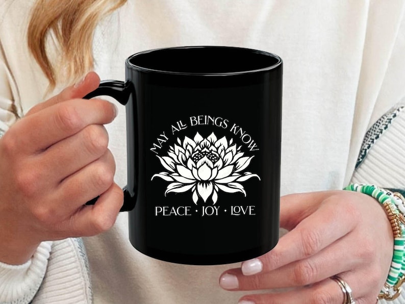 Buddhist mug featuring a lotus and a blessing. Beatiful white design on black mug. Two sizes are available.