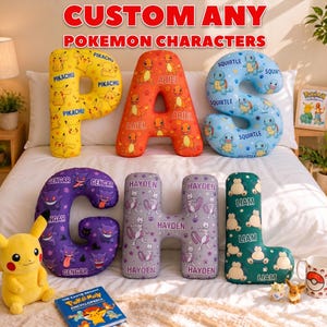 May include: Custom letter-shaped pillows featuring various Pokémon characters. The pillows are in the shape of the letters P, A, S, G, H, and L. Each letter is decorated with different Pokémon, such as Pikachu, Charmander, Squirtle, Gengar, and Mewtwo. The pillows are on a bed.