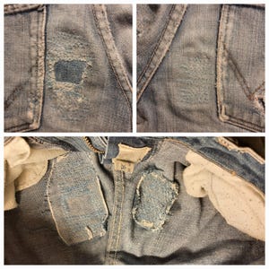 May include: Close-up of denim fabric with several distressed areas. The fabric has a light blue color and shows signs of wear and tear.