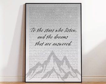 May include: A black and white image of a framed print with a quote from a fantasy novel. The quote reads "To the stars who listen, and the dreams that are answered." The print is on a white background with a subtle sparkle effect.