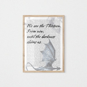 May include: A framed print with a black and white image of a dragon with the text "We are the thirteen. From now, until the darkness claims us."
