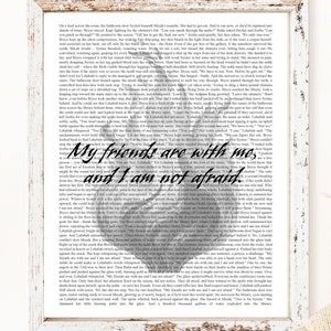 May include: A close-up of a page from a fantasy novel with a white background and black text. The text reads "My friends are with me, and I am not afraid." The text is surrounded by a decorative border.