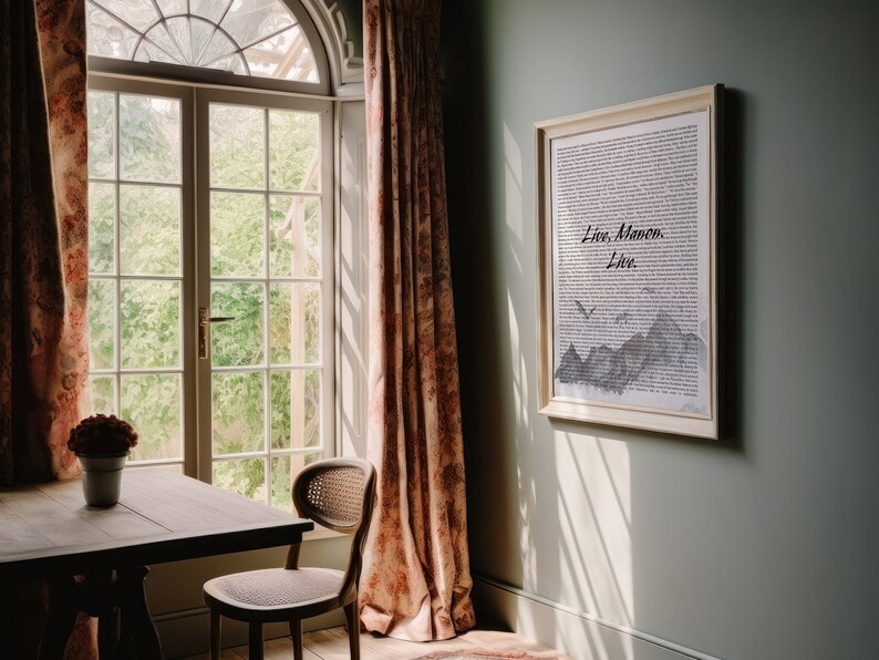 May include: A framed print with a black and white illustration of mountains and birds. The text "Live.  Manon.  Live." is written in cursive on the print.
