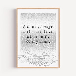 May include: A framed print with a light wood finish. The artwork features a background of printed text with the words "Aaron always fell in love with her. Everytime." in a bold, black font, with a simple line drawing.