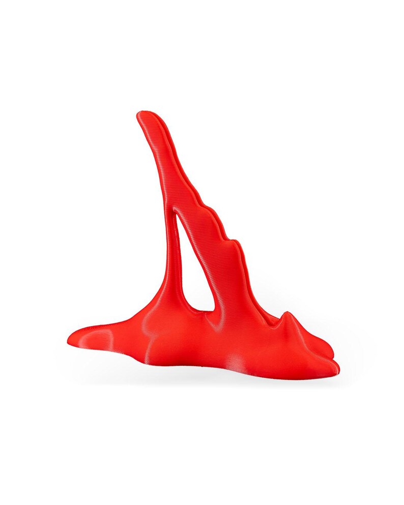 May include: A bright red, abstract, 3D printed sculpture with a smooth, glossy finish. The sculpture has a unique, organic shape with a flowing, fluid design.