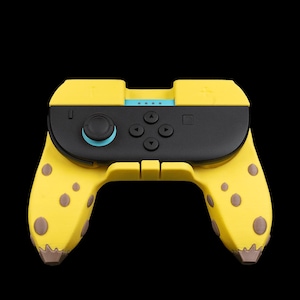 May include: A yellow and black video game controller with a unique design. The controller features a black center section with buttons and a joystick, and yellow handles with brown spots. The joystick is light blue.