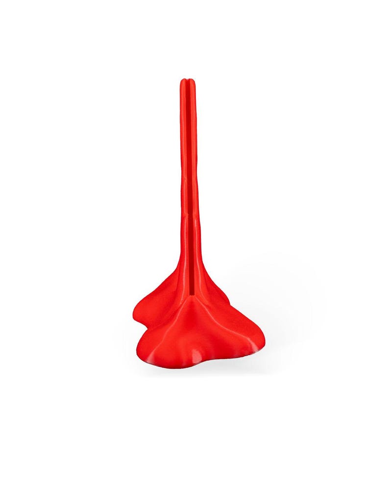 May include: A bright red plastic shoe stand with a tall, narrow, vertical design. The stand has a wide, flat base with a rounded, heart-shaped design.