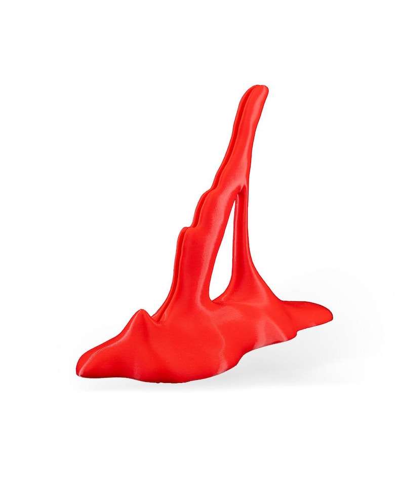 May include: A bright red, abstract, 3D printed sculpture with a tall, thin, vertical form and a wide, flat base.