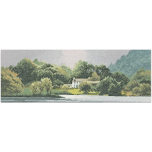 May include: A cross-stitch landscape depicting a white house surrounded by green trees and foliage. A body of water is in the foreground, with a mountain range in the background. The sky is a light grey colour.