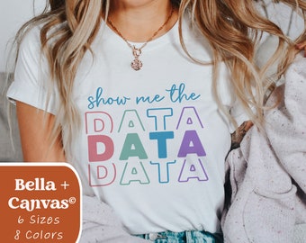 May include: White t-shirt with the text "show me the DATA" in rainbow colors. The text is stacked with each word in a different color.