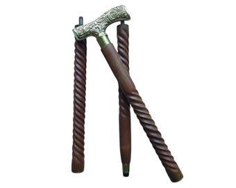 May include: A wooden walking stick with a brass handle featuring an intricate floral design. The stick is made of dark brown wood and has a twisted design.
