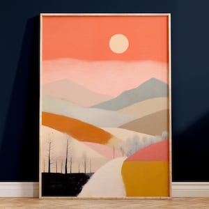 Könnte beinhalten: Ein gerahmtes abstraktes Landschaftsbild mit einer weißen Sonne in einem rosa und orangefarbenen Himmel über einer Reihe von Hügeln in Braun-, Orange-, Rosa- und Blautönen.