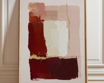 May include: Abstract art print in a wooden frame. The artwork features layered brushstrokes in shades of red, pink, and cream, with gold accents. The painting is displayed against a light background, creating a modern and elegant aesthetic.