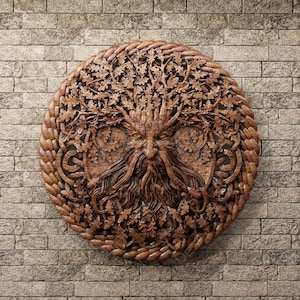 May include: A circular wooden carving of a green man with a beard and hair made of leaves. The carving is surrounded by a rope-like border and is set against a brick wall.