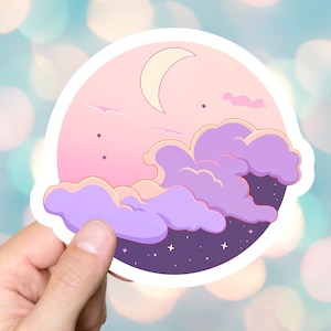 May include: A sticker with a pink and purple sky with clouds and a crescent moon. The background is a dark purple with white stars.