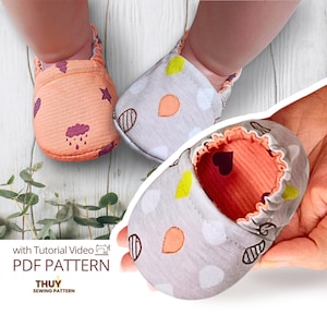 May include: Soft fabric baby shoes featuring a peach-colored pair with purple rain cloud and star patterns, and a grey pair with colorful teardrop shapes. The text reads with Tutorial Video PDF PATTERN THUY SEWING PATTERN.