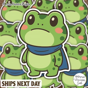 May include: Green frog sticker with a blue scarf and pink cheeks. The sticker has a white border and the text "Kevin Hodder Design" is at the top. The sticker is waterproof and dishwasher safe. The text "Ships Next Day" is at the bottom.