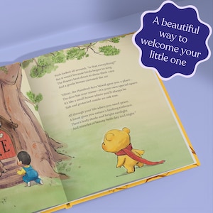 Pode incluir: Um livro infantil aberto com ilustra&ccedil;&otilde;es de Winnie the Pooh e uma crian&ccedil;a. O texto diz: &laquo;Uma bela maneira de receber seu pequeno&raquo;. O livro tem p&aacute;ginas amarelas e um fundo roxo.