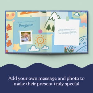May include: Open book with a personalized page for Benjamin, featuring a photo, sun, clouds, and text. The book's design includes illustrations of a sun, clouds, and mountains, with a message about peace and dreams.