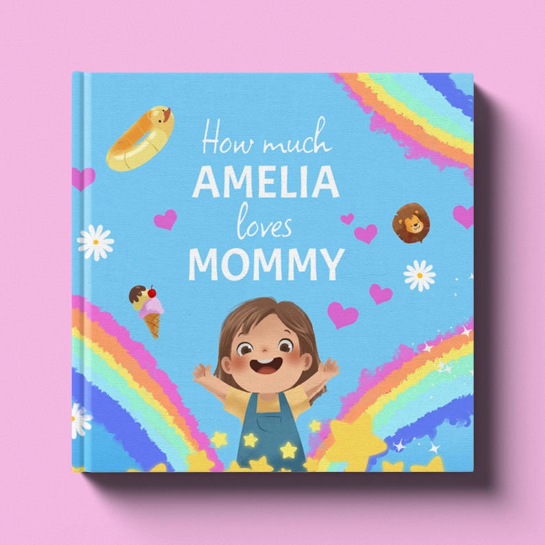 A blue children's book cover displaying a cartoon toddler with her arms spread in the center of two rainbows and exploding stars. The cover has little pink hearts, white daisies, neopolitan ice cream, a yellow ducky floaty, and a cartoon lion head. The book sits on a pink background.