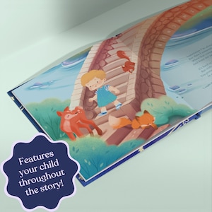 May include: Open children's book illustration featuring a bridge scene with a cartoon child in a blue dress and foxes. The text "Features your child throughout the story!" is visible on a dark blue starburst.