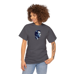 May include: A dark grey t-shirt with a blue and white image of a man's face on the front.