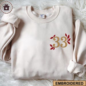 Embroidered Expedition 33 Sweatshirt and Hoodie, Distressed Gold “33” & Red Petal Gamer Shirt, Perfect Gift for Game Fans, Gaming Sweatshirt