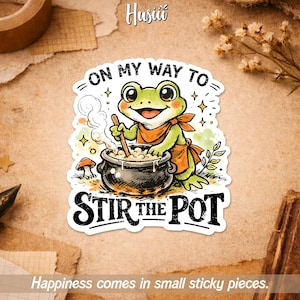 May include: A sticker featuring a cartoon frog stirring a pot, with the text "ON MY WAY TO STIR THE POT." The frog is green with an orange apron and scarf. The sticker also includes the text "Happiness comes in small sticky pieces."