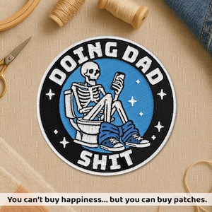 May include: Embroidered patch with a skeleton on a toilet, holding a phone. The patch has the words "DOING DAD SHIT" in white on a black and blue background. Four white stars are around the edge.