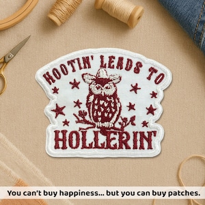 May include: Embroidered patch featuring a maroon owl in a cowboy hat, with the text "HOOTIN' LEADS TO HOLLERIN'". The patch has a white border and star accents. The bottom of the image reads "You can't buy happiness... but you can buy patches."