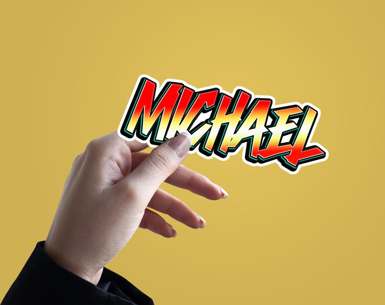 May include: A colorful sticker with the name "MICHAEL" written in a bold, stylized font. The sticker has a red, orange, yellow, and green gradient.