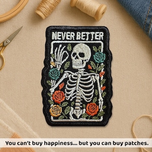 May include: Embroidered patch with a black border featuring a skeleton with a skull, surrounded by colorful roses and the text "NEVER BETTER." The patch also includes the text "You can't buy happiness... but you can buy patches."