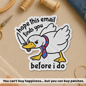 May include: Embroidered patch featuring a white duck with a knife, wearing a red and blue striped scarf. Text on the patch reads "hope this email finds you before I do." The patch has yellow feet and a yellow beak. The patch is on a beige fabric.