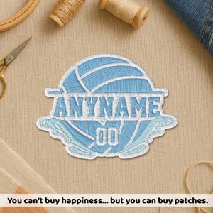 May include: A light blue embroidered patch with the text "ANYNAME" and the number "00" in a stylized font. The patch is in the shape of a volleyball. The text at the bottom reads: "You can't buy happiness... but you can buy patches."