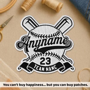May include: Embroidered baseball patch with the text "Anyname", number "23", and "TEAM NAME" in black on a white baseball design. The patch includes crossed baseball bats. The bottom of the image reads "You can't buy happiness... but you can buy patches."