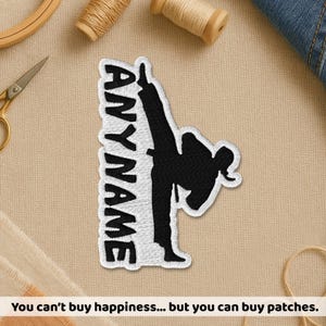 May include: Embroidered patch featuring a black martial artist performing a high kick, with the word "ANYNAME" in white. The patch has a white border. The image also includes text that says "You can't buy happiness... but you can buy patches."
