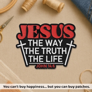 May include: Embroidered patch with the word "JESUS" in red, above the text "THE WAY THE TRUTH THE LIFE" in white, with "JOHN 14:6" below. The patch is black with a white border. Sewing supplies are in the background.