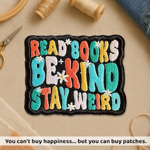 May include: Embroidered patch with the words "READ BOOKS BE KIND STAY WEIRD" in colorful letters. The patch has a black border and small flower accents. The text "You can't buy happiness... but you can buy patches" is at the bottom.