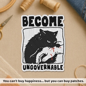 May include: Embroidered patch with the words "BECOME UNGOVERNABLE" above and below a black cat biting a hand with red blood. The patch is white with black stitching and a black border. The text at the bottom says "You can't buy happiness... but you can buy patches."