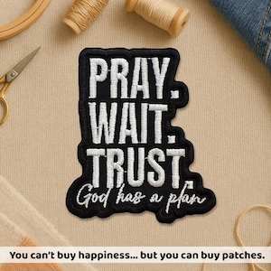 May include: A white ceramic mug with a black handle and the text "But First, Coffee" in a bold, black font. The mug is on a wooden surface. The mug is approximately 10 cm tall.