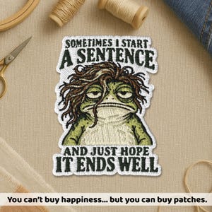 May include: An embroidered patch featuring a green frog with messy brown hair and a tired expression. The text reads: SOMETIMES I START A SENTENCE AND JUST HOPE IT ENDS WELL. The patch has a white border and is designed for fabric application.