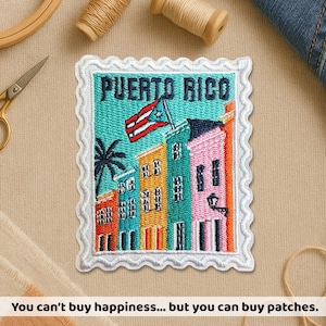 May include: Embroidered patch featuring a colorful depiction of Puerto Rican buildings and a flag. The patch has a white scalloped border and the words "Puerto Rico" at the top. The text at the bottom reads: "You can't buy happiness... but you can buy patches."
