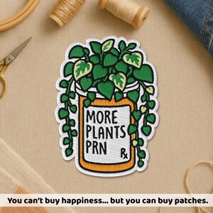 May include: Embroidered patch featuring a green and yellow plant design inside an orange pill bottle. The text "MORE PLANTS PRN R" is displayed on the bottle. The patch is surrounded by a white border. The phrase "You can't buy happiness... but you can buy patches" is at the bottom.
