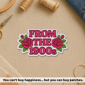 May include: Embroidered patch with the text "FROM THE 1900s" in pink, surrounded by pink roses and green leaves. The patch has a white border and is on a beige fabric surface. The patch is a decorative item.